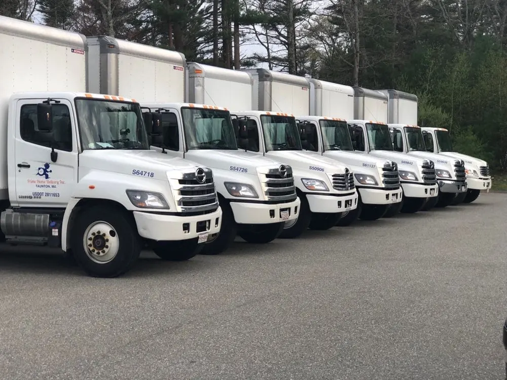 Row of Prime Home Delivery moving trucks