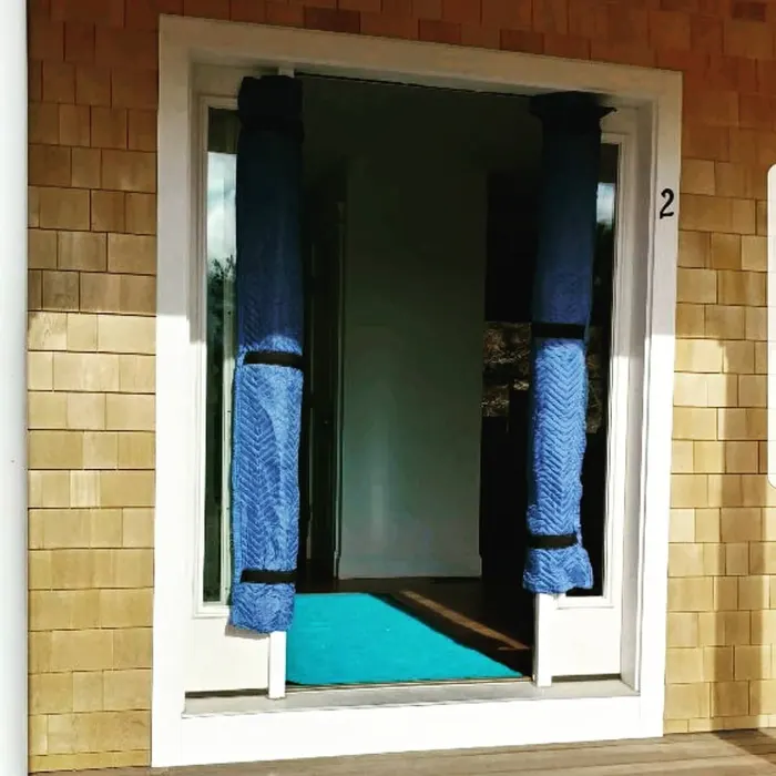 Door frame protected with blue moving pads